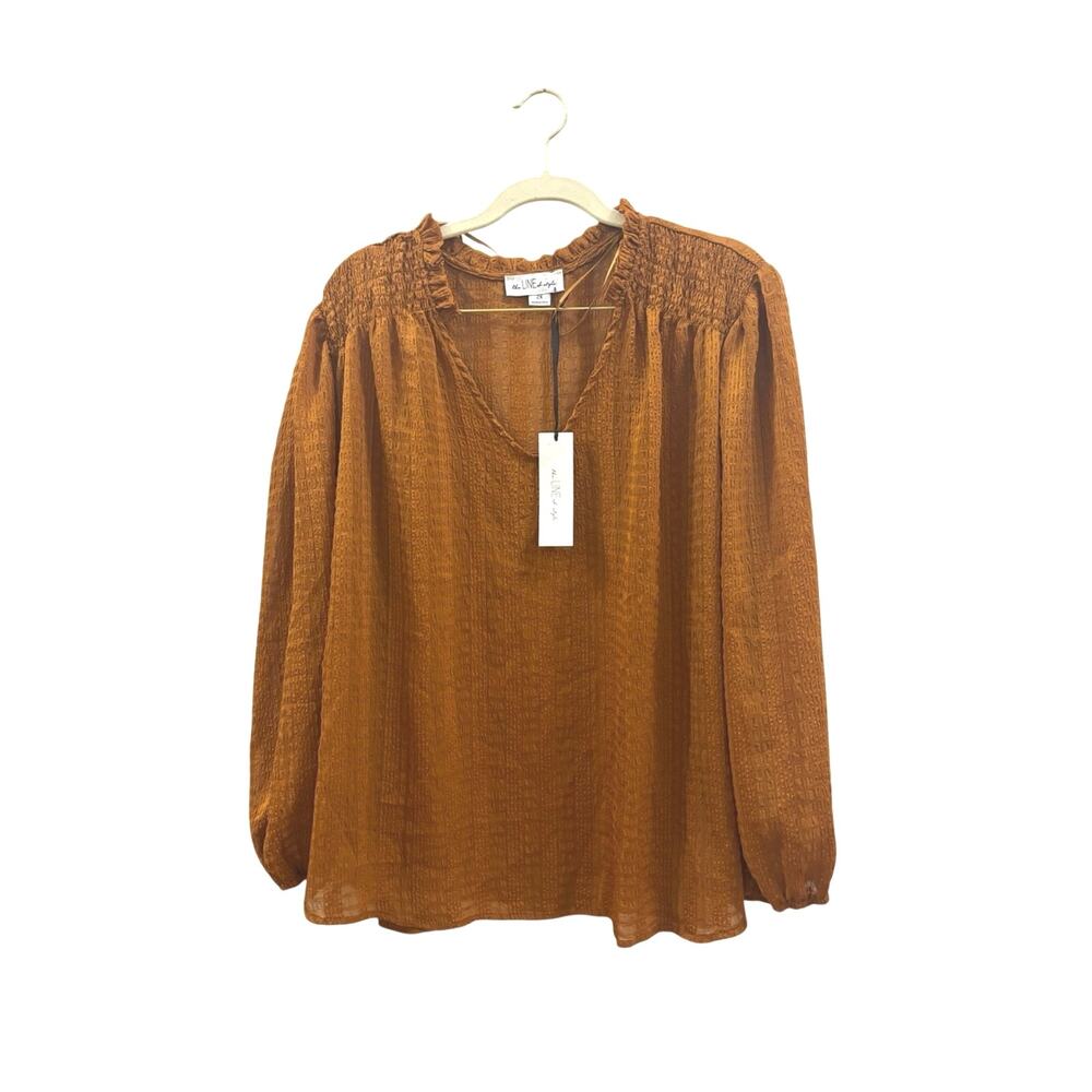 The line of style Burnt Orange Smocked Yoke Long-Sleeve Blouse